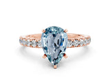 Rose gold Pear Cut Aquamarine Solitaire Ring with Pavé Accents and Four-Prong Setting