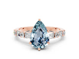 Rose gold Pear Cut Aquamarine Solitaire with Side Baguettes and Channel Set Band
