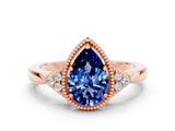Rose gold Pear Cut Blue Sapphire Halo Ring with Tapered Band and Four-Prong Setting