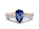 Rose gold Pear Cut Blue Sapphire Prong Setting with Side Stones on a Pave Band