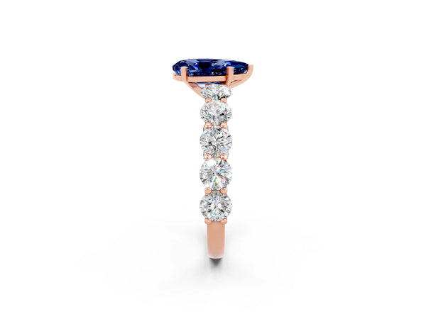 Rose gold Pear Cut Blue Sapphire Prong Setting with Side Stones on a Pave Band