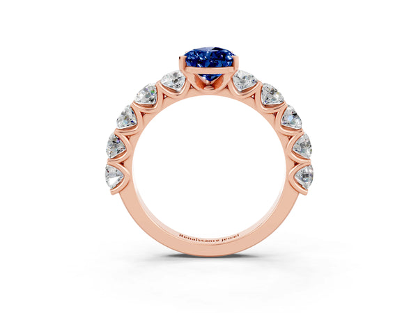 Rose gold Pear Cut Blue Sapphire Prong Setting with Side Stones on a Pave Band