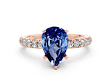 Rose gold Pear Cut Blue Sapphire Solitaire Ring with Pavé Accents and Four-Prong Setting