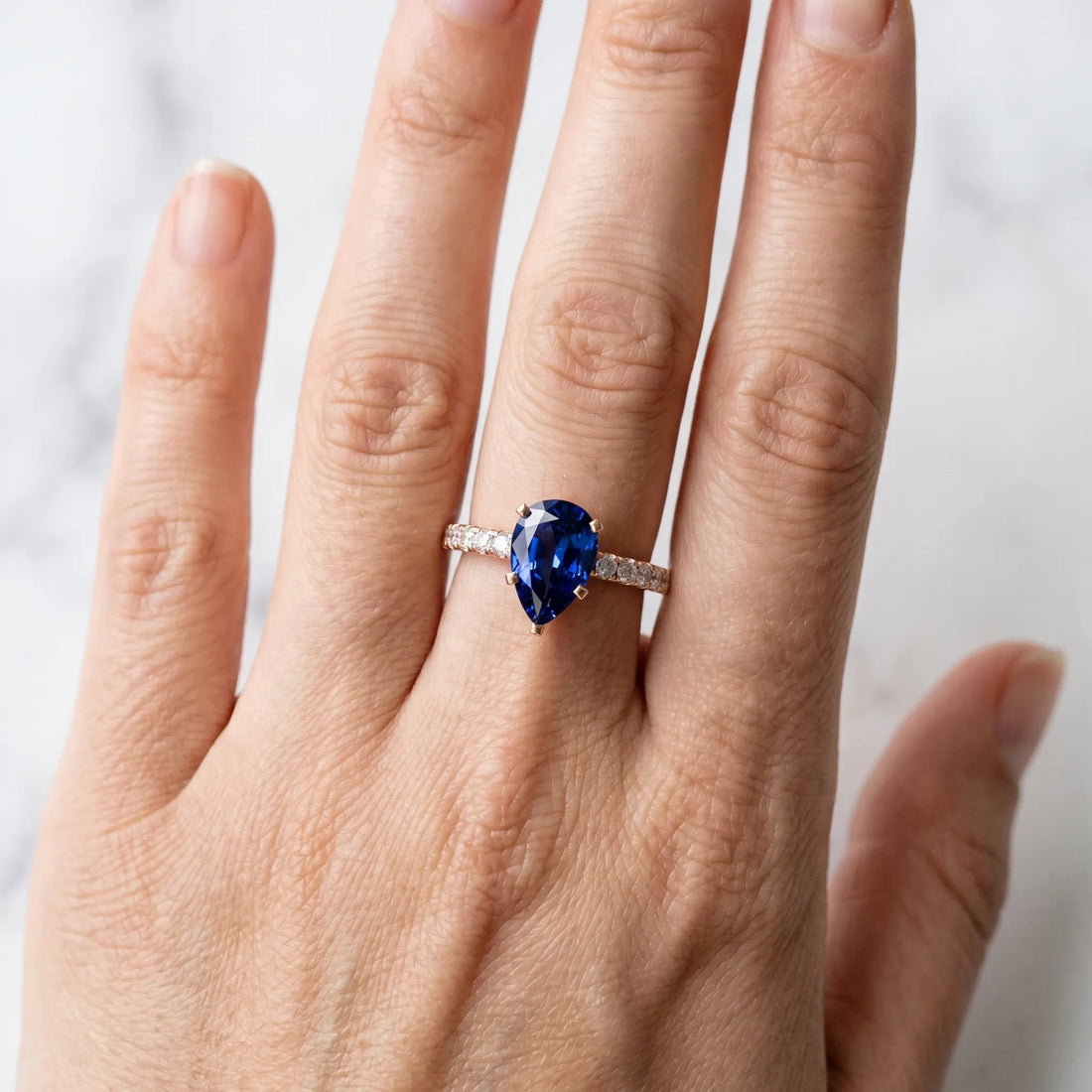 Rose gold Pear Cut Blue Sapphire Solitaire Ring with Round  Pavé Band and Four-Prong Setting_42