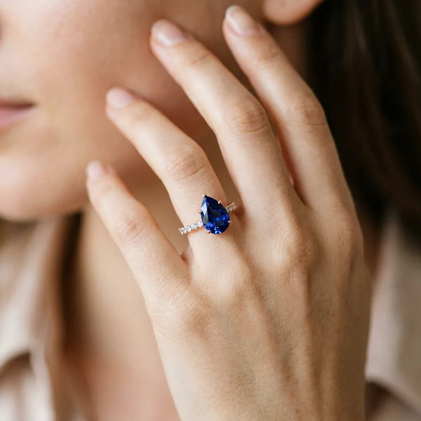 Rose gold Pear Cut Blue Sapphire Solitaire Ring with Round  Pavé Band and Four-Prong Setting