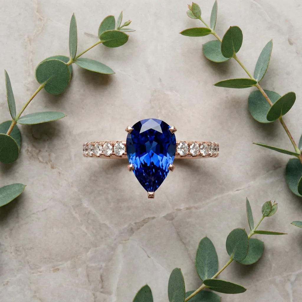 Rose gold Pear Cut Blue Sapphire Solitaire Ring with Round  Pavé Band and Four-Prong Setting_45