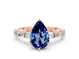 Rose gold Pear Cut Blue Sapphire Solitaire with Side Baguettes and Channel Set Band