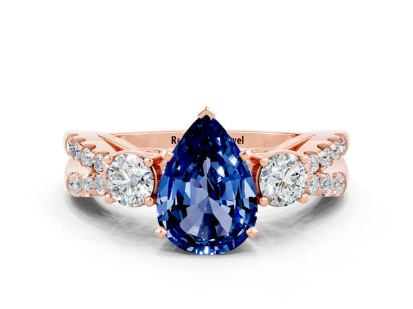 Rose gold Pear Cut Blue Sapphire Three-Stone Ring with Pavé Split Shank and Four-Prong Setting