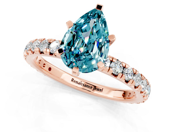 Rose gold Pear Cut Blue Topaz Pavé Solitaire Ring with Round Band and Prong Setting