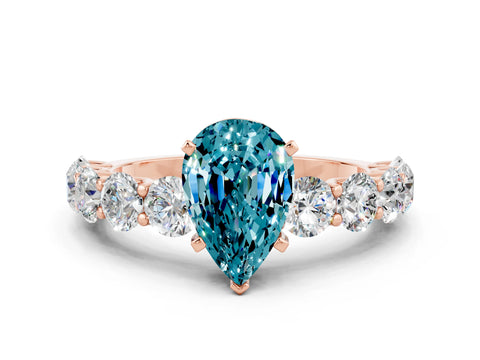 Rose gold Pear Cut Blue Topaz Prong Setting with Side Stones on a Pave Band