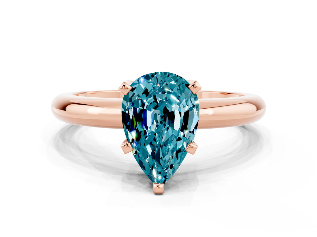 Rose gold Pear Cut Blue Topaz Solitaire Engagement Ring with Round Band and Four-Prong Setting
