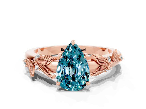Rose gold Pear Cut Blue Topaz Solitaire Ring with Leaf Motif Band and Four-Prong Setting