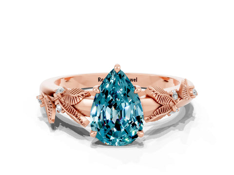 Rose gold Pear Cut Blue Topaz Solitaire Ring with Leaf Motif Band and Four-Prong Setting
