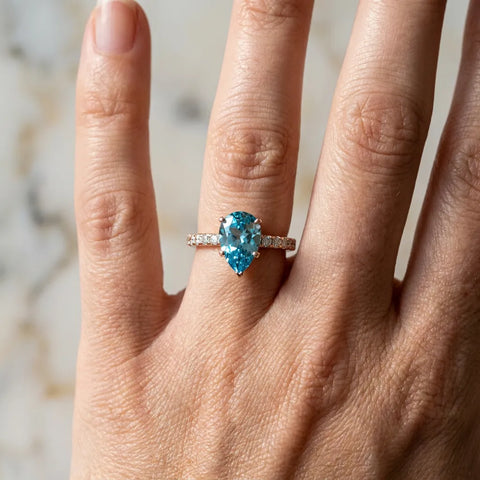 Rose gold Pear Cut Blue Topaz Solitaire Ring with Round  Pavé Band and Four-Prong Setting_42