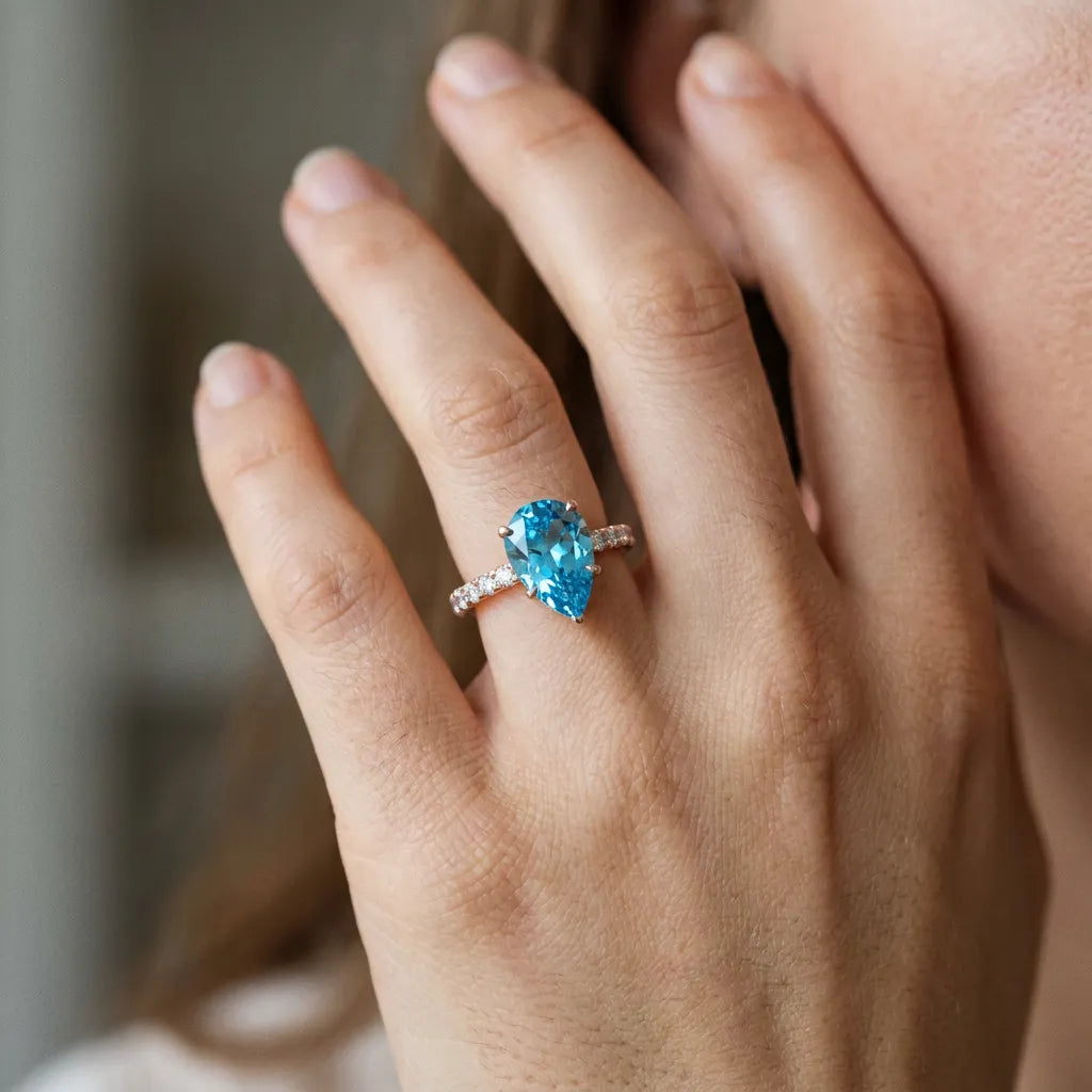 Rose gold Pear Cut Blue Topaz Solitaire Ring with Round  Pavé Band and Four-Prong Setting_44