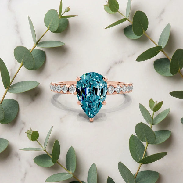 Rose gold Pear Cut Blue Topaz Solitaire Ring with Round Pavé Band and Four-Prong Setting