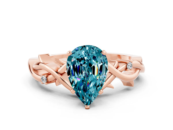 Rose gold Pear Cut Blue Topaz Solitaire Ring with Twisted Band and Prong Setting
