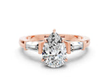 Rose gold Pear Cut Cut Diamond Ring with Tapered Baguette Side Stones in Four-Prong Setting
