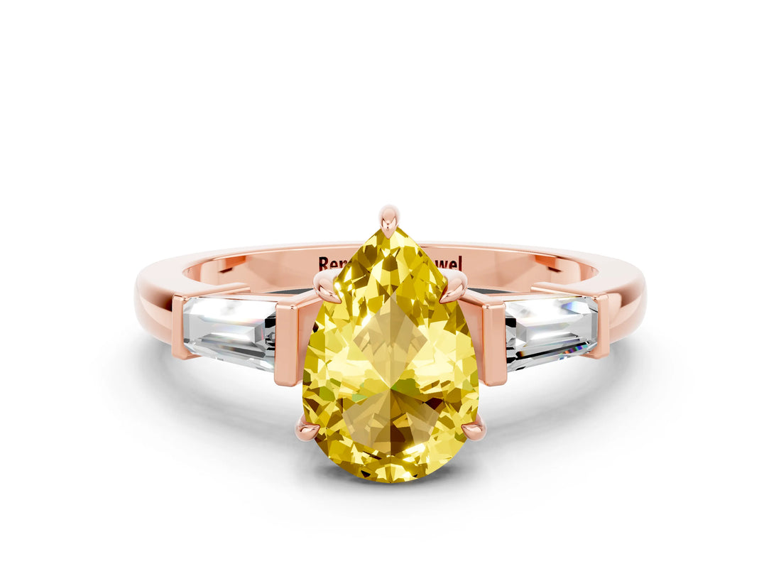 Rose gold Pear Cut Cut Diamond Ring with Tapered Baguette Side Stones in Four-Prong Setting