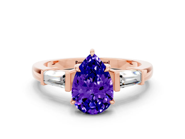 Rose gold Pear Cut Tanzanite Three-Stone Ring with Tapered Baguette Side Stones and Prong Setting