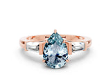 Rose gold Pear Cut Cut Diamond Ring with Tapered Baguette Side Stones in Four-Prong Setting
