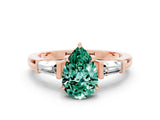 Rose gold Pear Cut Cut Diamond Ring with Tapered Baguette Side Stones in Four-Prong Setting