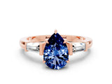 Rose gold Pear Cut Cut Diamond Ring with Tapered Baguette Side Stones in Four-Prong Setting