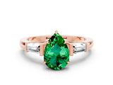 Rose gold Pear Cut Cut Diamond Ring with Tapered Baguette Side Stones in Four-Prong Setting