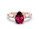 Rose gold Pear Cut Cut Diamond Ring with Tapered Baguette Side Stones in Four-Prong Setting