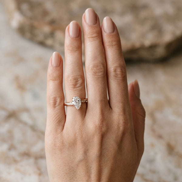 Rose gold Pear Cut Diamond Engagement Ring with Side Stone Accents and Four-Prong Setting