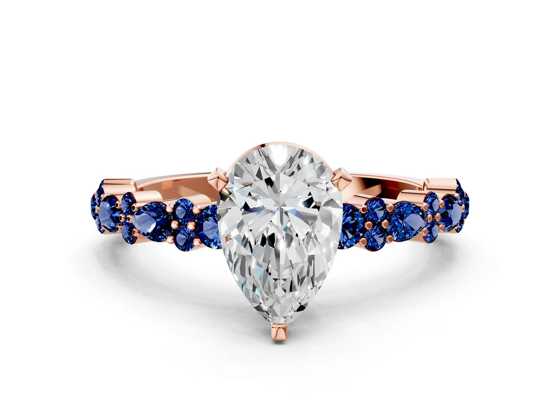 Rose gold Pear Cut Diamond Side Stone Solitaire Ring with Round with Blue Sapphire side stone and Four-Prong Setting