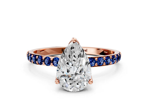 Rose gold Pear Cut Diamond Solitaire Engagement Ring with Round with Blue Sapphire side stone Pavé Band and Prong Setting
