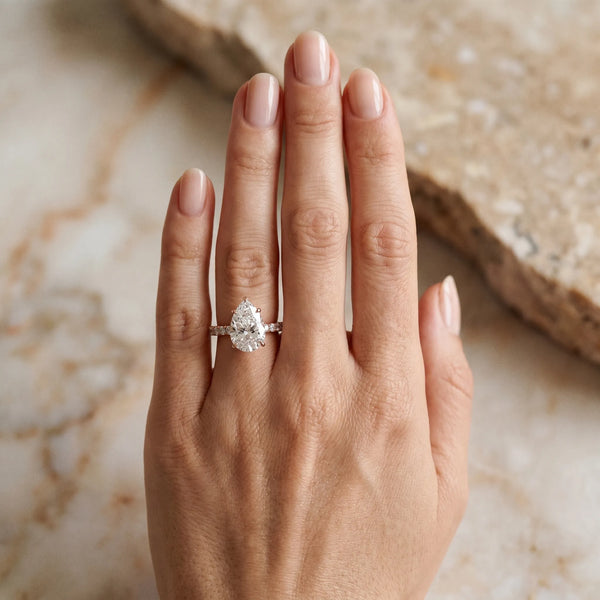 Rose gold Pear Cut Diamond Solitaire Ring with Pavé Accents and Four-Prong Setting