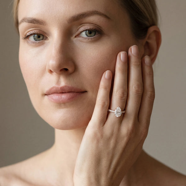 Rose gold Pear Cut Diamond Solitaire Ring with Pavé Accents and Four-Prong Setting