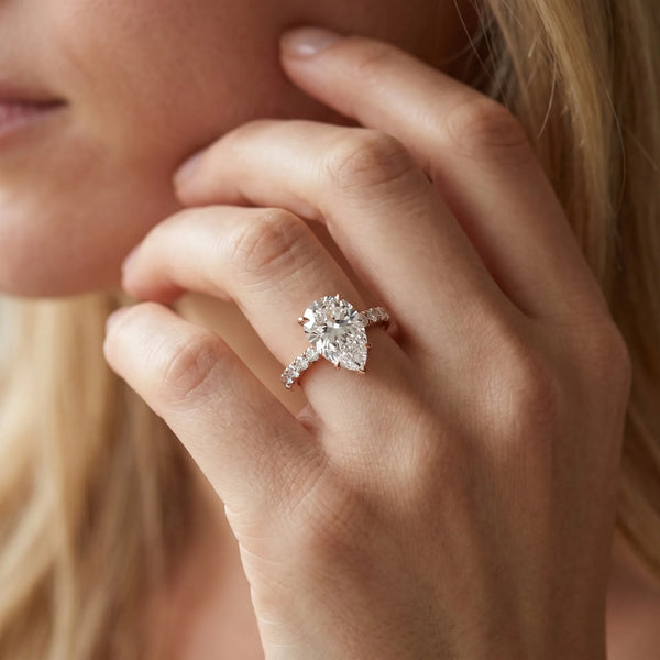 Rose gold Pear Cut Diamond Solitaire Ring with Pavé Accents and Four-Prong Setting