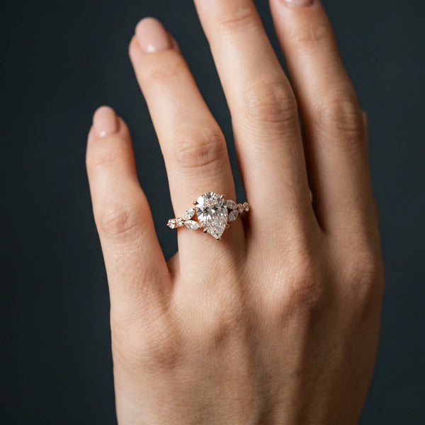 Rose gold Pear Cut Diamond Solitaire Ring with Side Stones and Four-Prong Setting