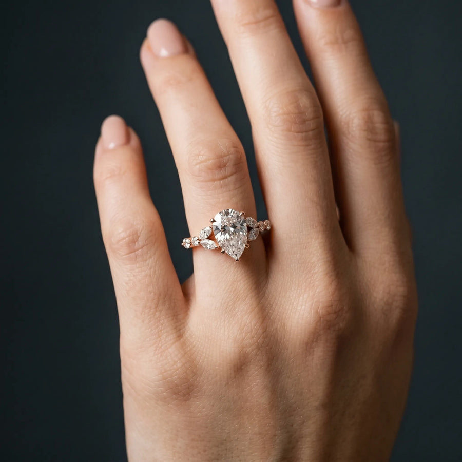 Rose gold Pear Cut Diamond Solitaire Ring with Side Stones and Four-Prong Setting