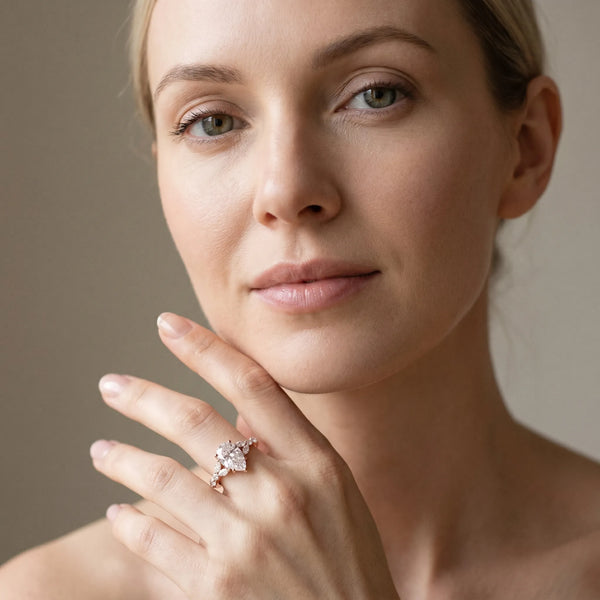 Rose gold Pear Cut Diamond Solitaire Ring with Side Stones and Four-Prong Setting