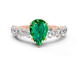 Rose gold Pear Cut Emerald Prong Setting with Side Stones on a Pave Band