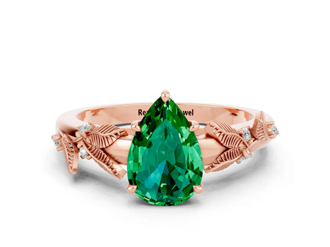 Rose gold Pear Cut Emerald Solitaire Ring with Leaf Motif Band and Four-Prong Setting