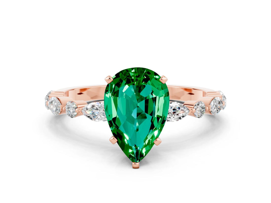 Rose gold Pear Cut Emerald Solitaire with Side Stones on a Pavé Band and Four-Prong Setting