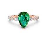Rose gold Pear Cut Emerald Solitaire with Side Stones on a Pavé Band and Four-Prong Setting
