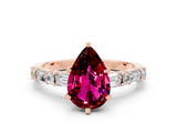 Rose gold Pear Cut Garnet Solitaire with Side Baguettes and Channel Set Band