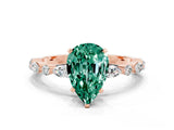 Rose gold Pear Cut Green Sapphire Solitaire with Side Stones on a Pavé Band and Four-Prong Setting