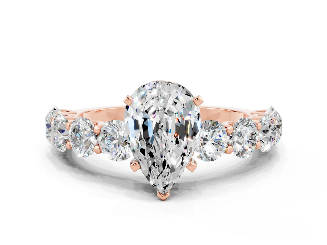 Rose gold Pear Cut Moissanite Prong Setting with Side Stones on a Pave Band