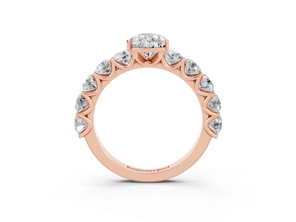Rose gold Pear Cut Moissanite Prong Setting with Side Stones on a Pave Band