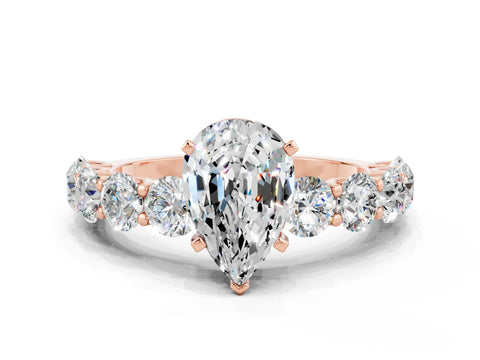 Rose gold Pear Cut Moissanite Prong Setting with Side Stones on a Pave Band