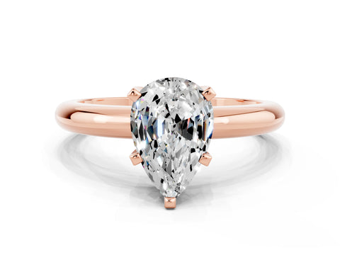 Rose gold Pear Cut Moissanite Solitaire Engagement Ring with Round Band and Four-Prong Setting