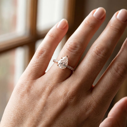 Rose gold Pear Cut Moissanite Solitaire Ring with Round  Pavé Band and Four-Prong Setting