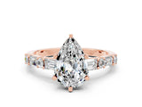 Rose gold Pear Cut Moissanite Solitaire with Side Baguettes and Channel Set Band